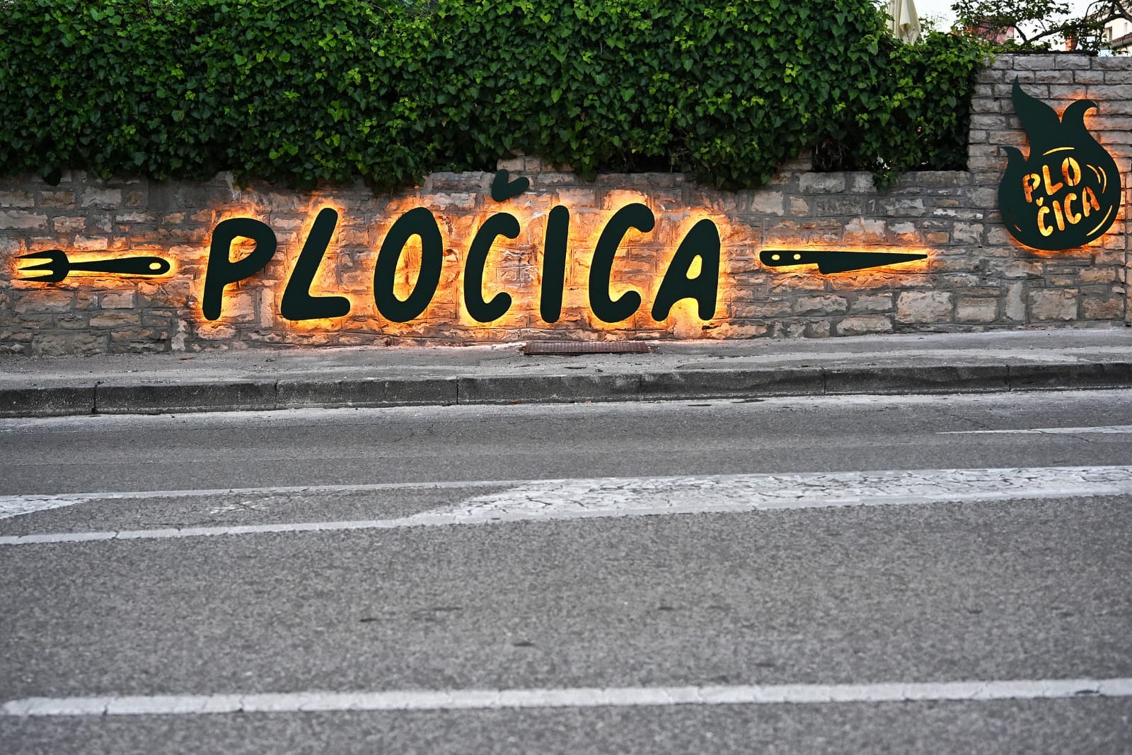 PLOČICA — wall sign at the Podroom location.