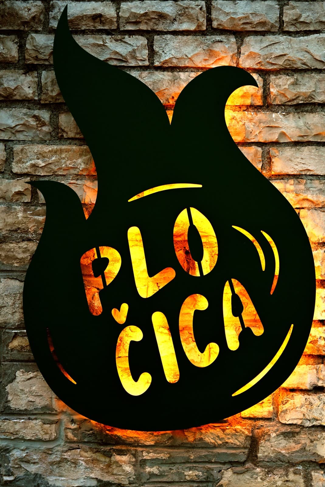 Pločica logo on a stone wall.